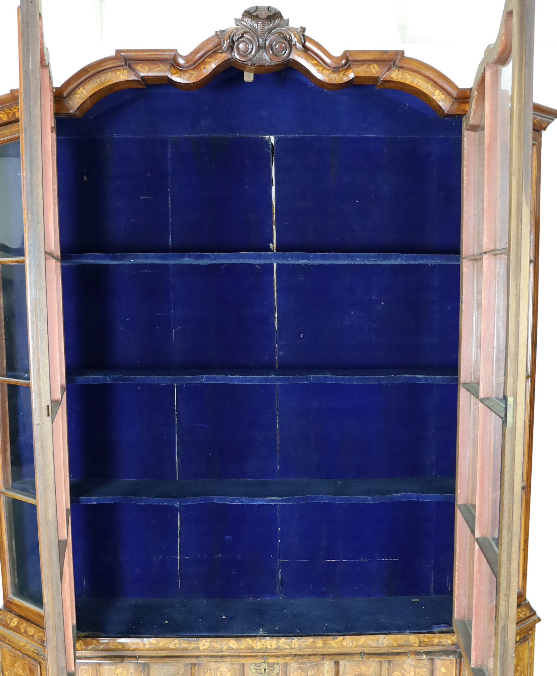 A late 18th century Dutch marquetry inlaid walnut serpentine display cabinet, width 186cm depth 36cm height 260cm